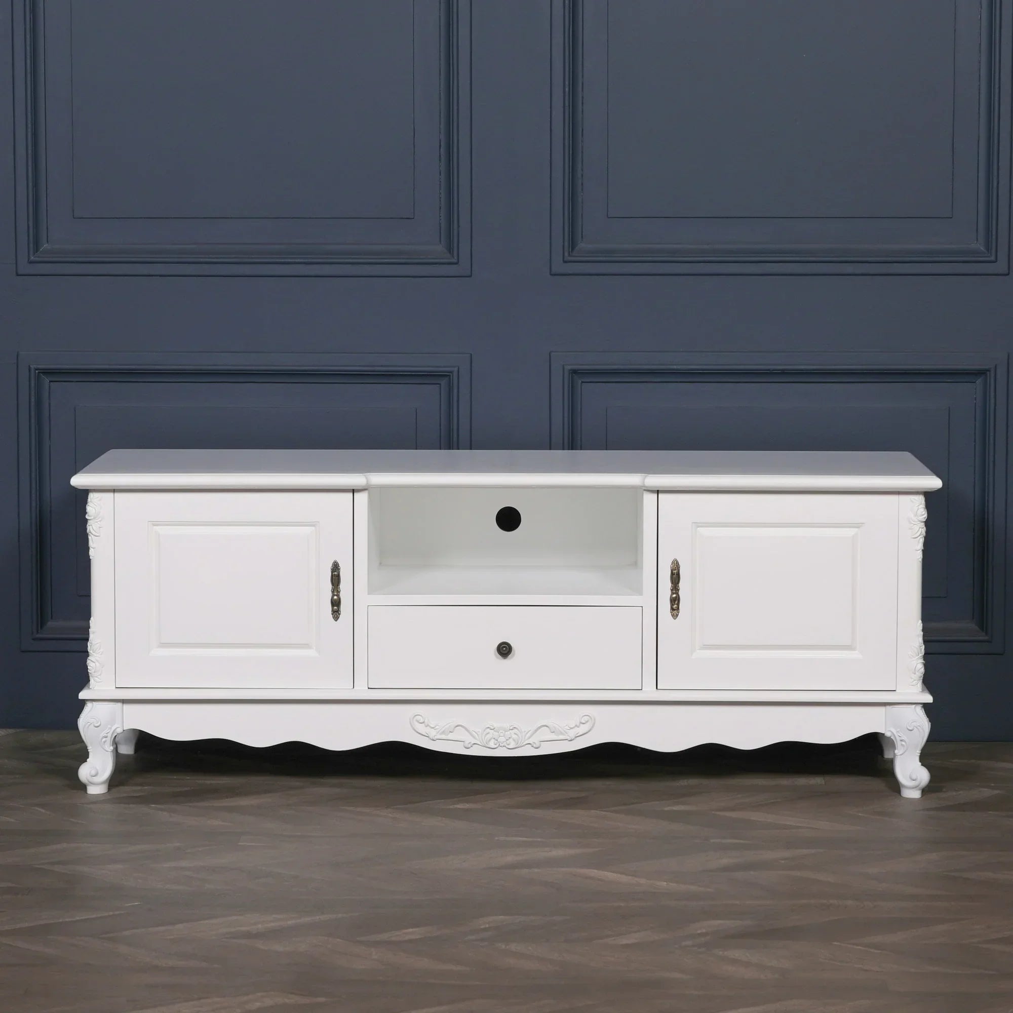 White TV unit with ornate legs, two cabinets, open shelf and central drawer