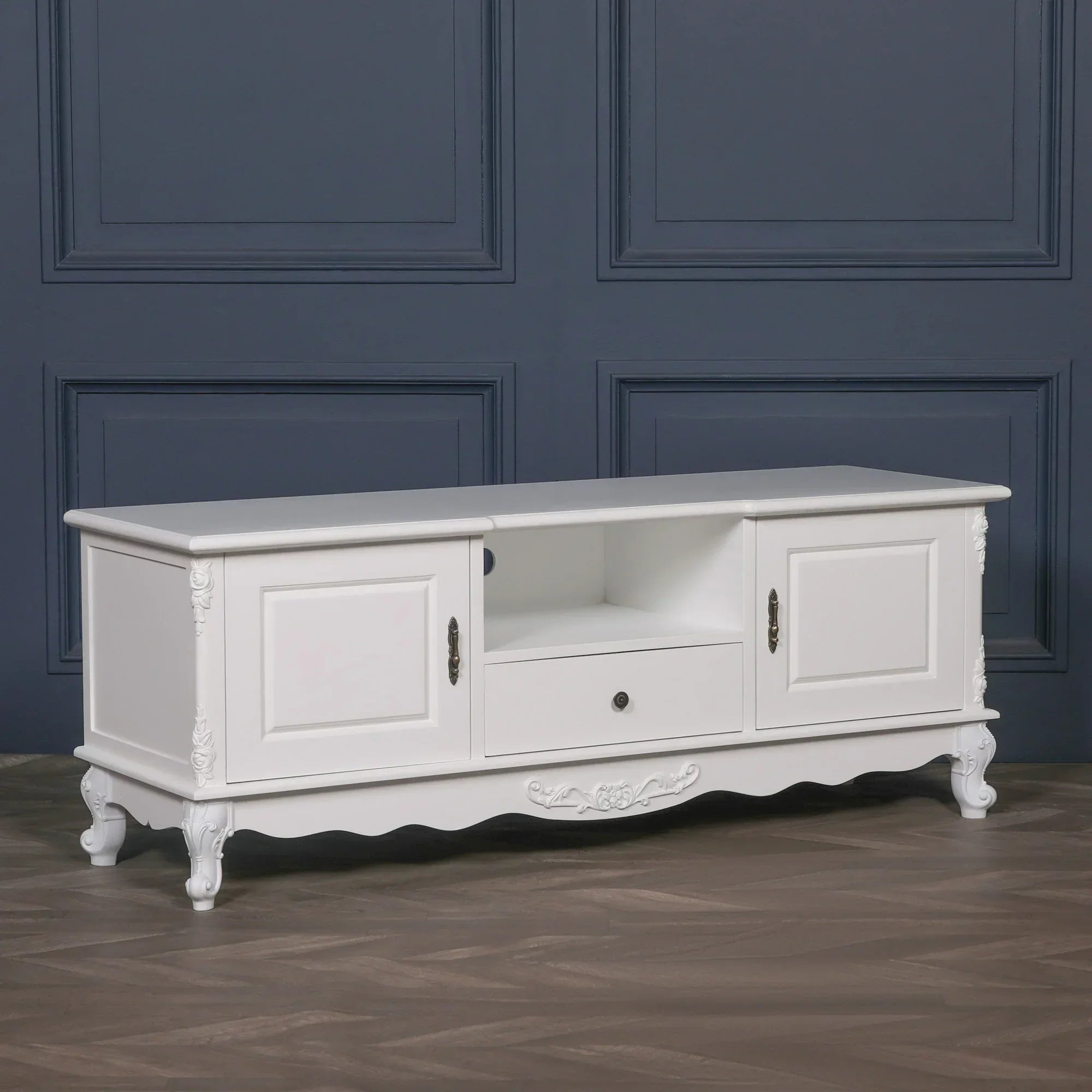 White wood TV unit with storage cabinets, drawer and carved detailing, front view