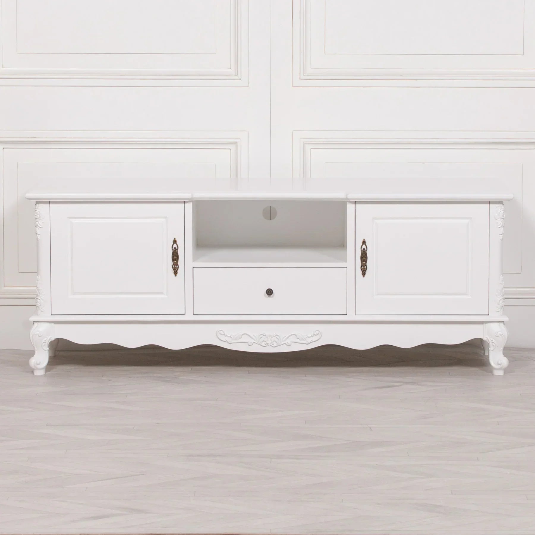 White TV unit with two cabinets, central open shelf, and decorative carved legs
