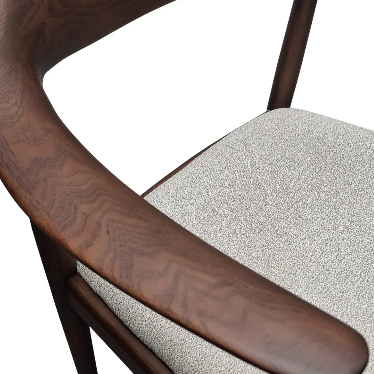 Curved wood chair armrest with textured light grey upholstered seat