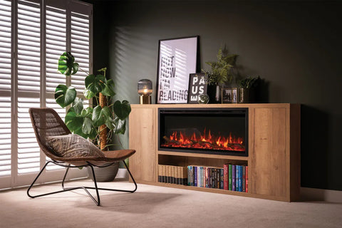 Atmos electric fire installed in a stylish living room with a wooden cabinet, plants, and a comfortable chair.
