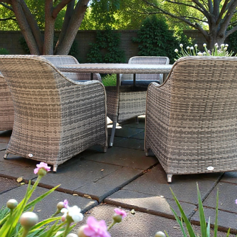 Rattan garden furniture set with six chairs and rectangular table on patio
