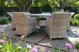 Rattan garden furniture set with six chairs and rectangular table on patio