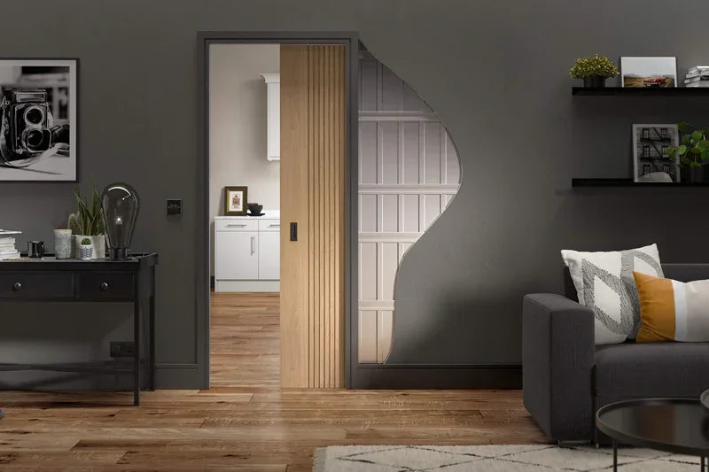 Oak pocket door set installed in modern living room with partial wall cutout