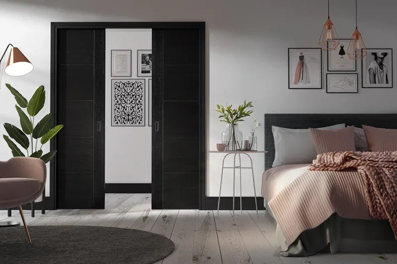 Black double pocket door set installed in modern bedroom with minimalist decor