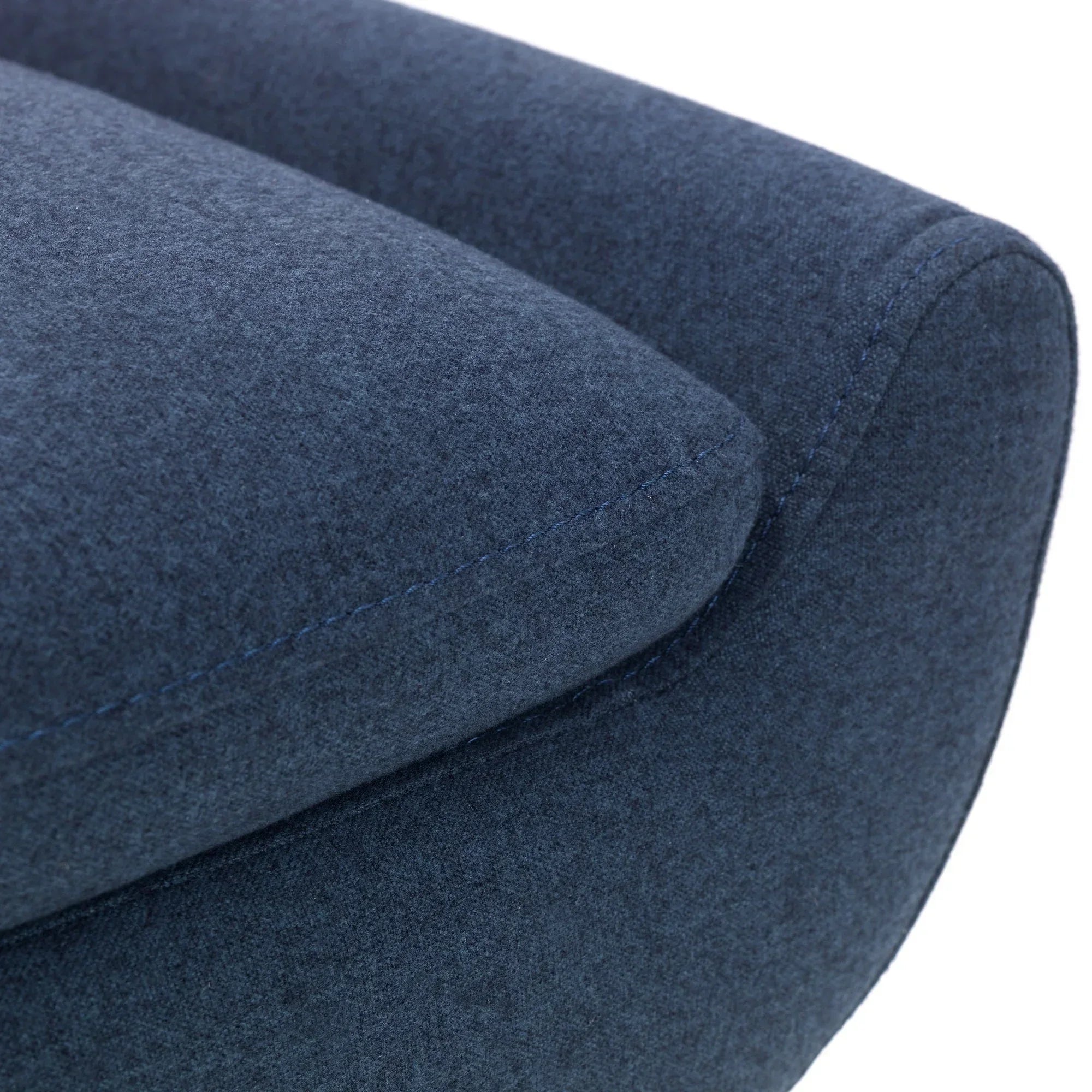 Close-up of blue fabric sofa armrest with visible stitching detail