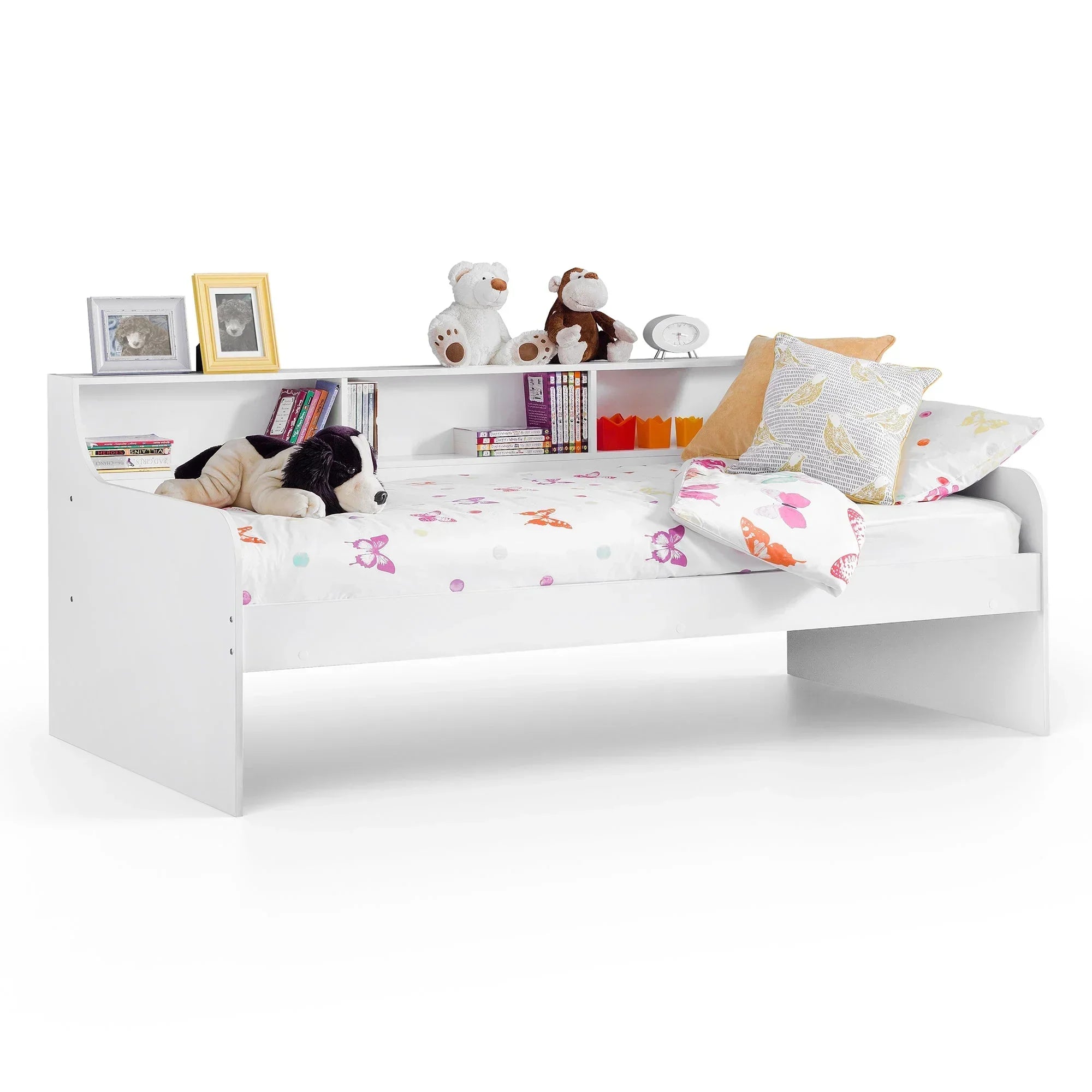 White daybed with built-in shelving, stuffed toys, books and butterfly bedding