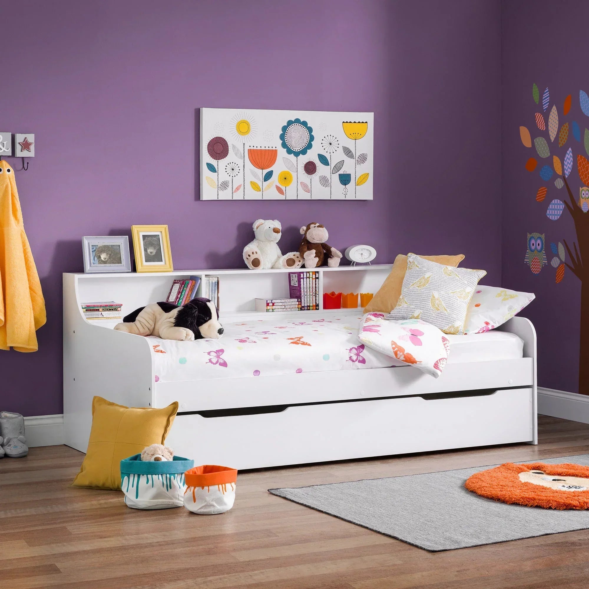White daybed with built-in storage and shelving in a colourful children's bedroom
