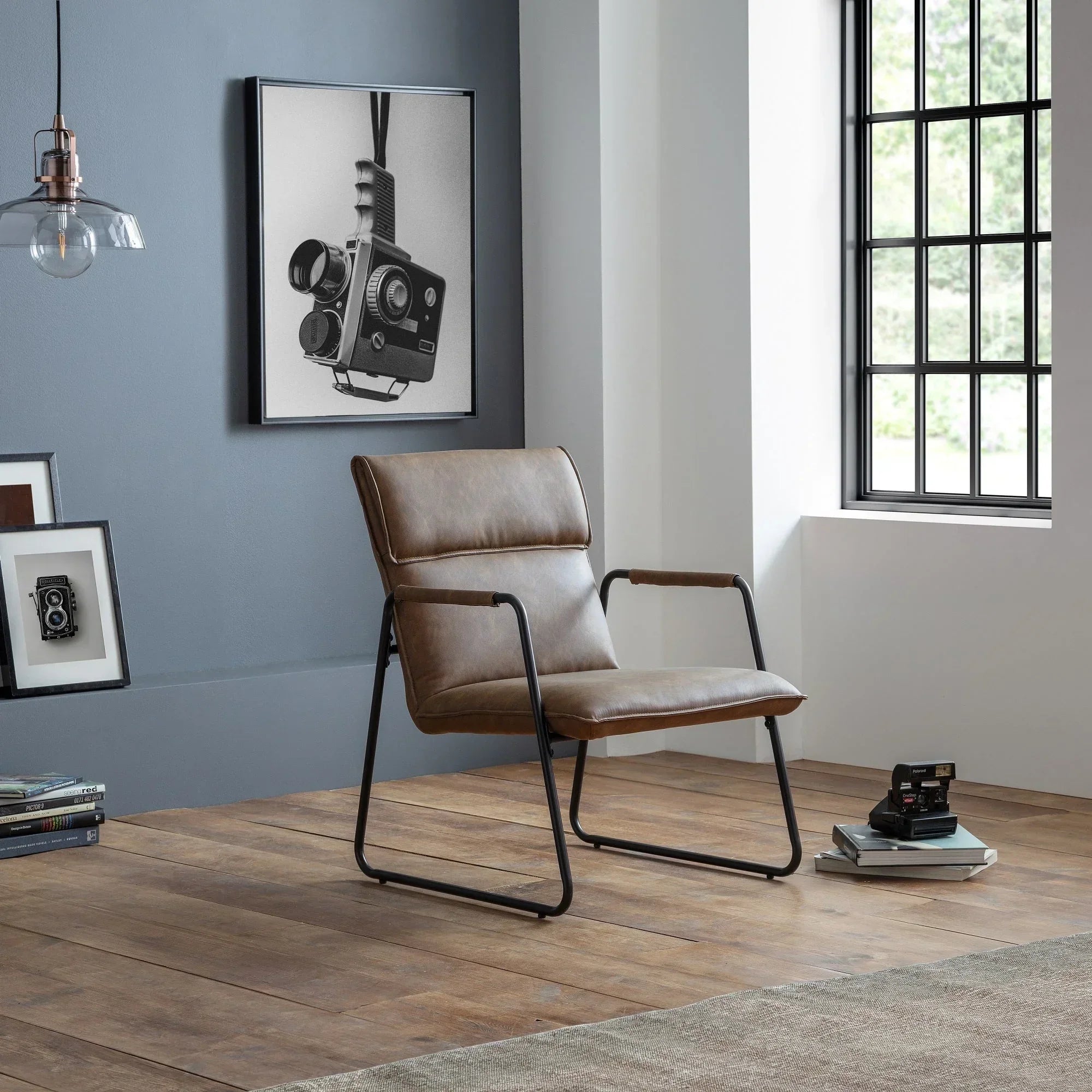 Brown leather Gramercy chair with black metal frame in modern living room