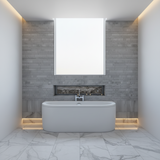 Modern freestanding bathtub in a bathroom setting with tiled wall and floor.