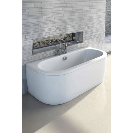 Modern freestanding bathtub in a bathroom setting with tiled wall and floor.