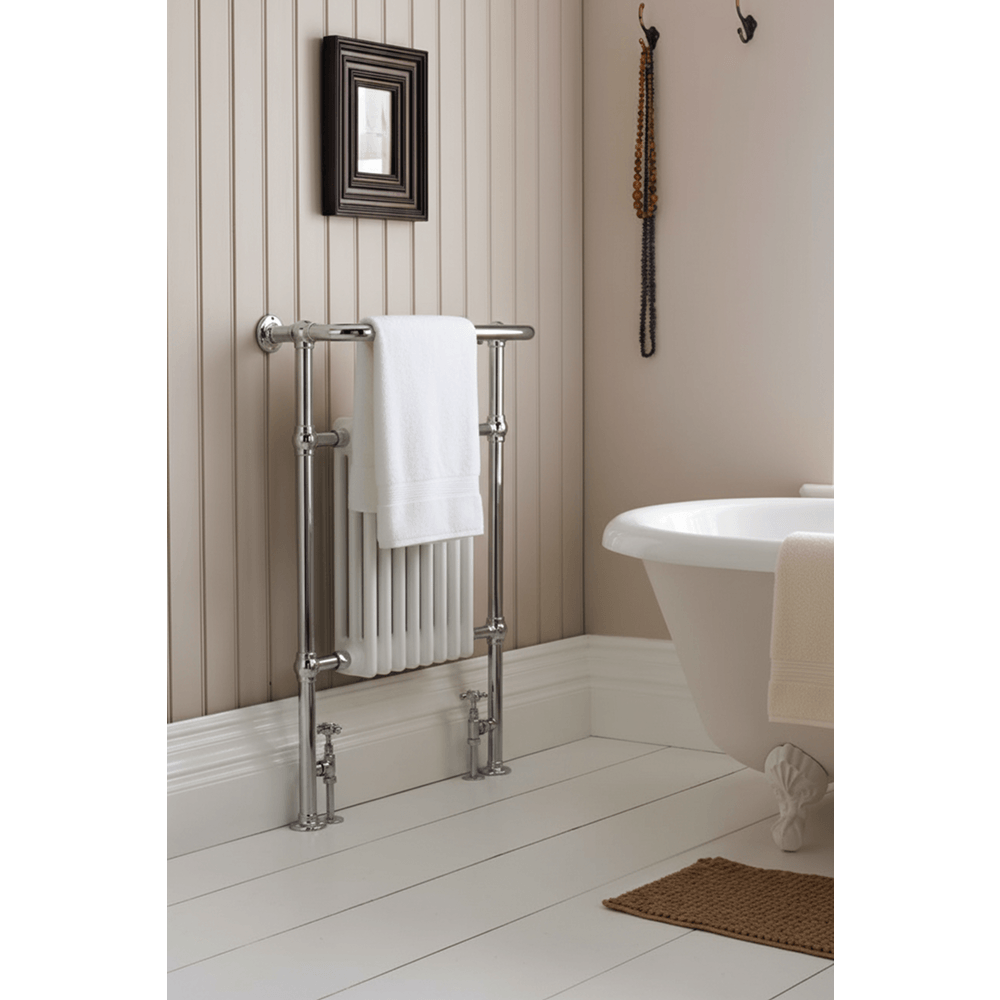 Bathroom with a towel rack, white bathtub, and decorative elements.