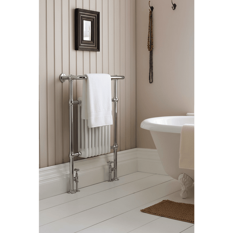 Bathroom with a towel rack, white bathtub, and decorative elements.