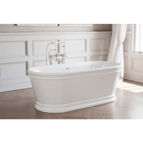 White freestanding bathtub in a bathroom with wooden flooring and white walls.