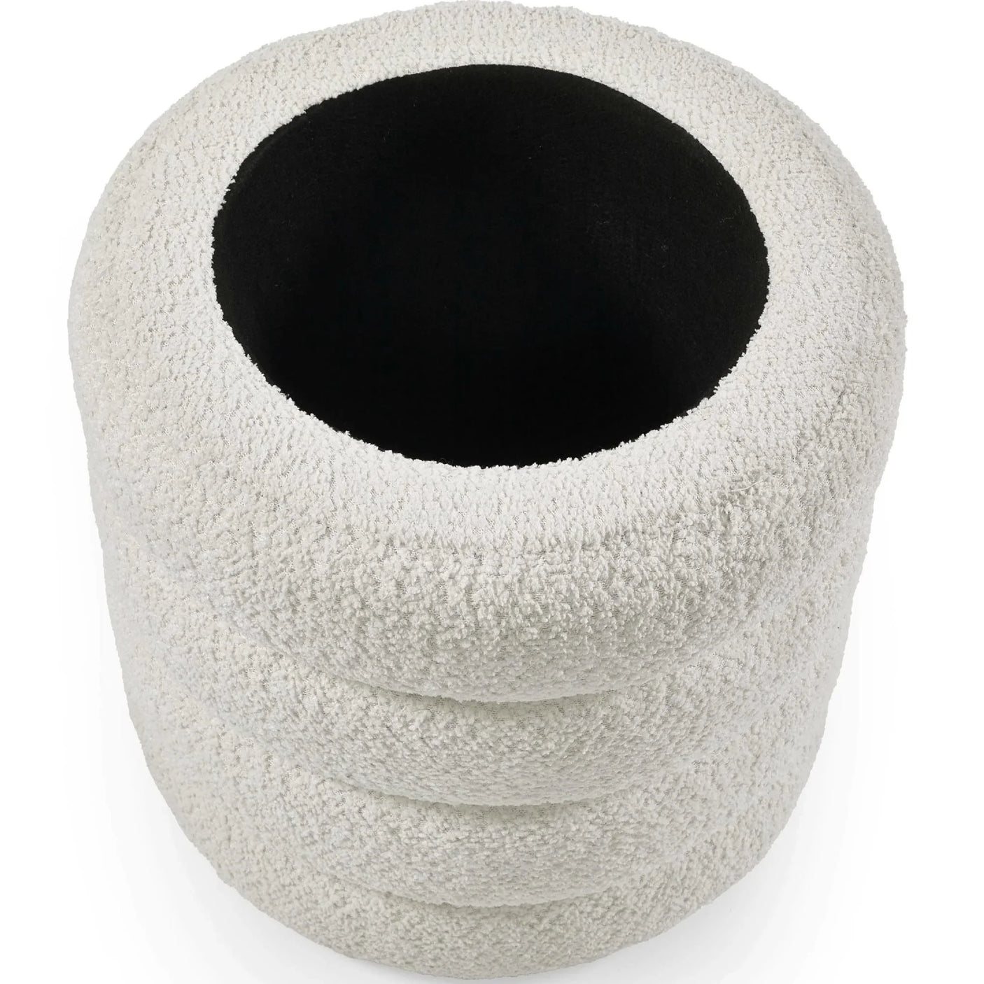 Round boucle ottoman with white textured fabric and black interior, top view