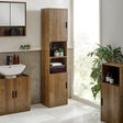 Tall bathroom cabinet with slatted wood doors, walnut finish, open middle shelves with plants and towels, near sink