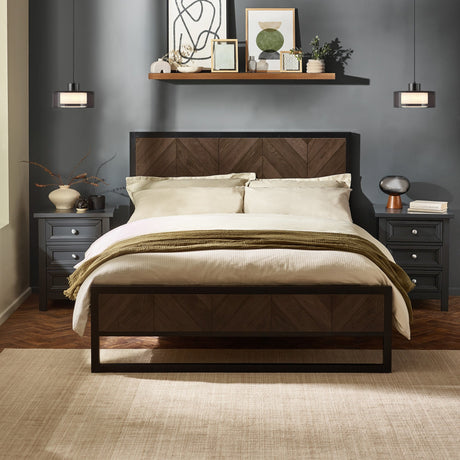 Herringbone patterned headboard and footboard bed in dark wood and black metal frame with bedding in a decorated gray room