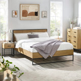 Modern oak bed frame with metal legs in bright bedroom, matching nightstand and chest