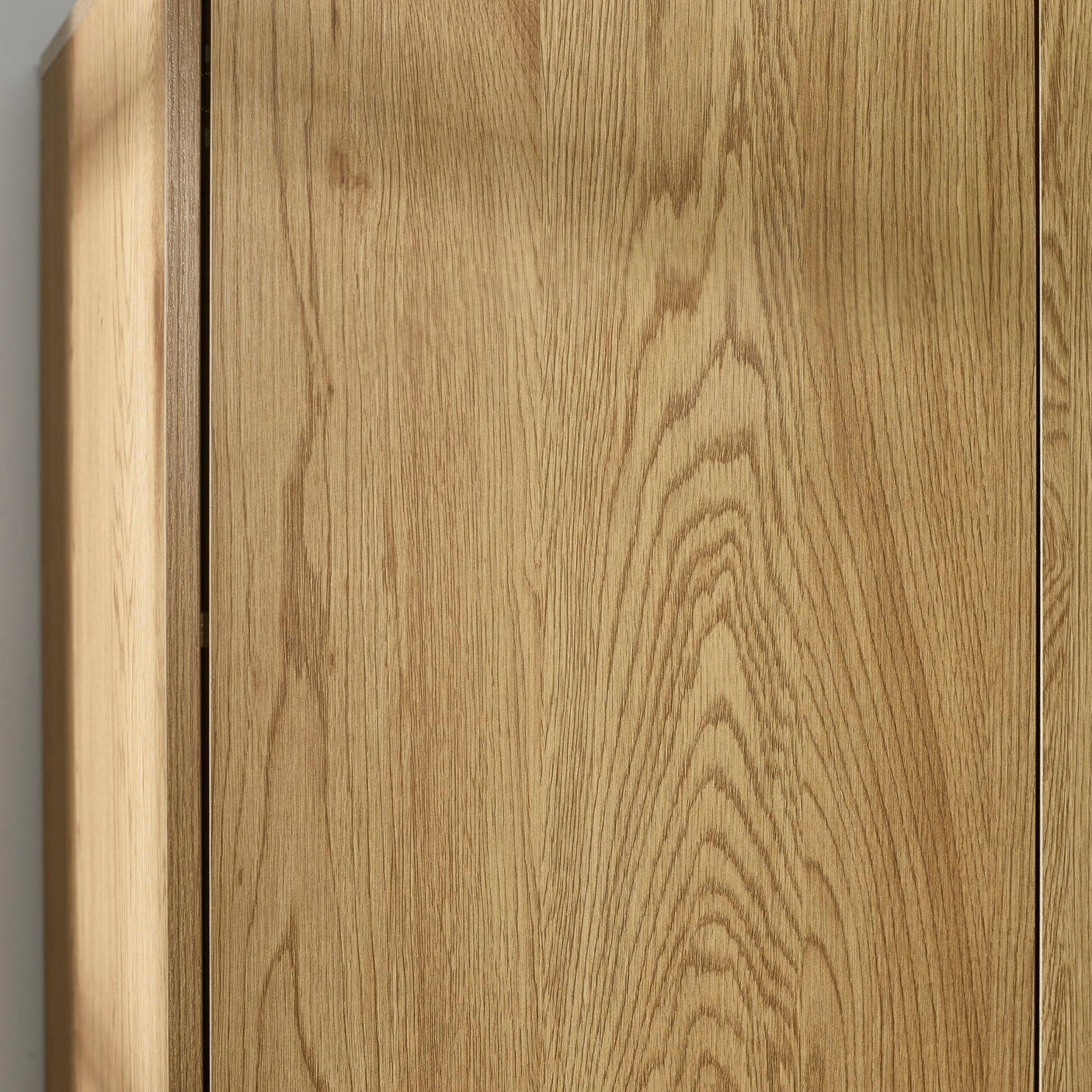 Close up of oak wardrobe doors showing wood grain texture and vertical panel design