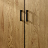 Oak effect wardrobe doors with black metal handles, close-up view of wood grain texture