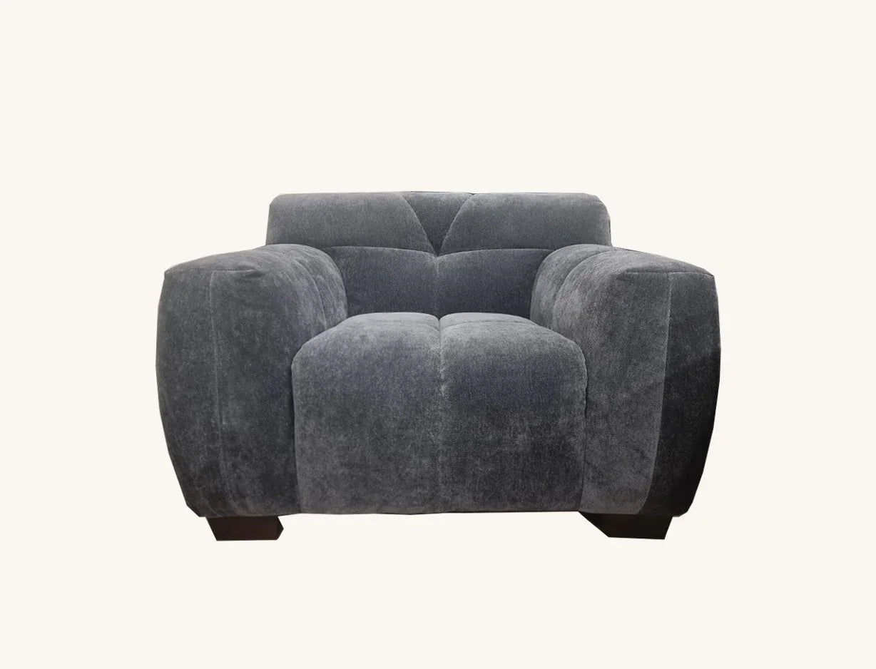Harlem chair in dark grey fabric with wide padded arms and low feet front view