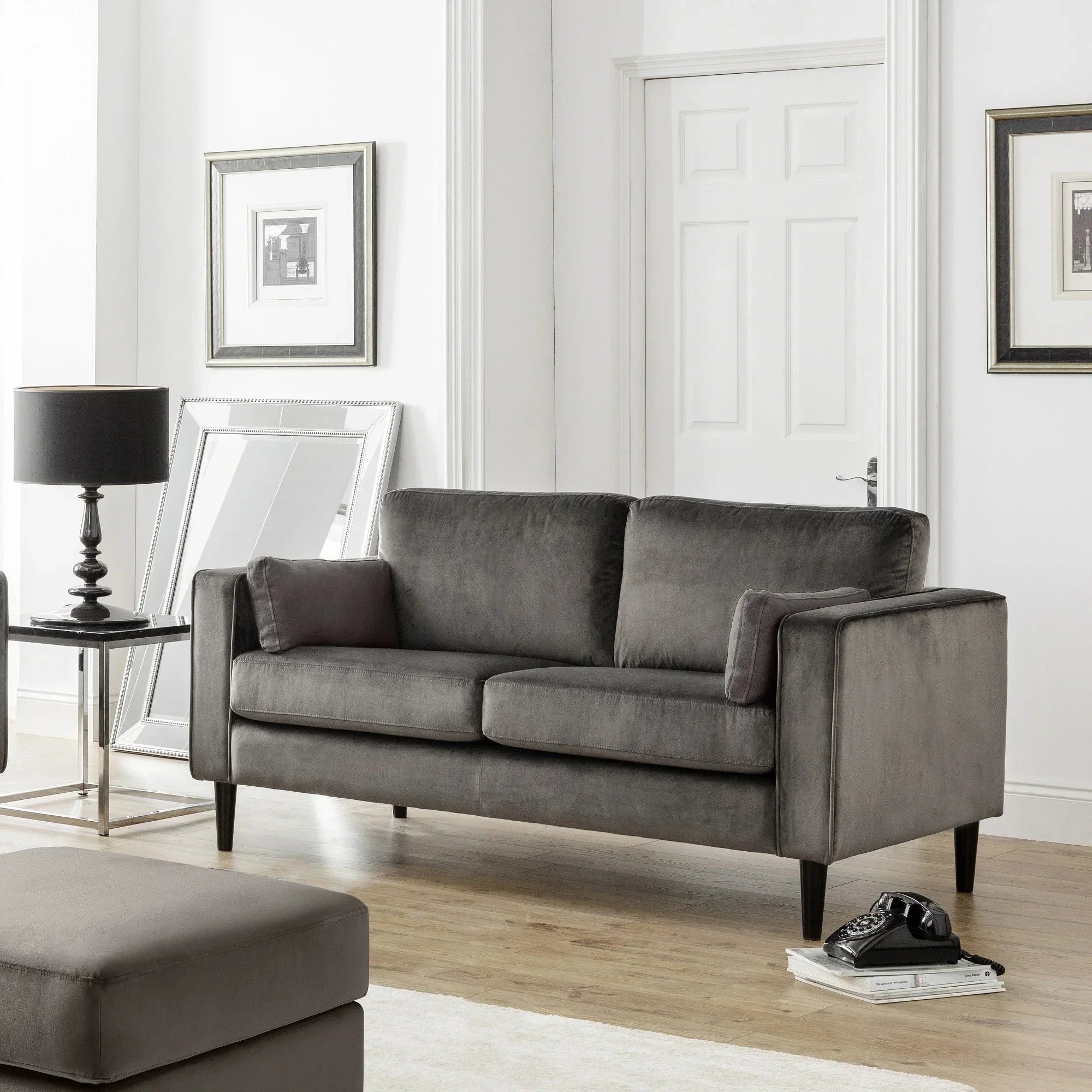Grey velvet sofa with straight arms and black legs in modern living room setting