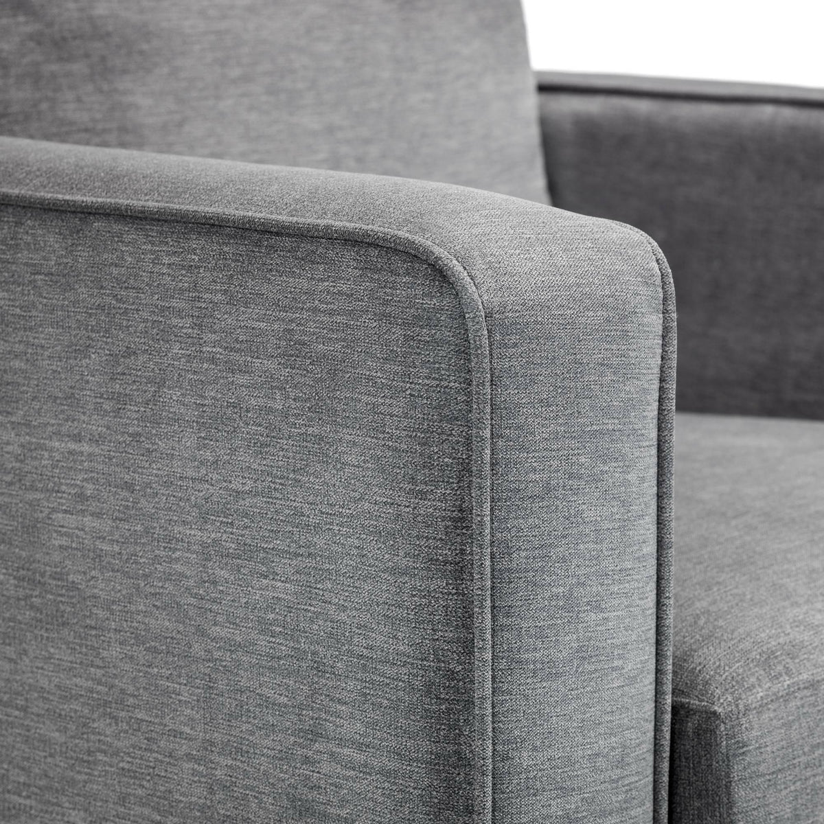 Close-up of dark grey chenille chair armrest and seat upholstery detail