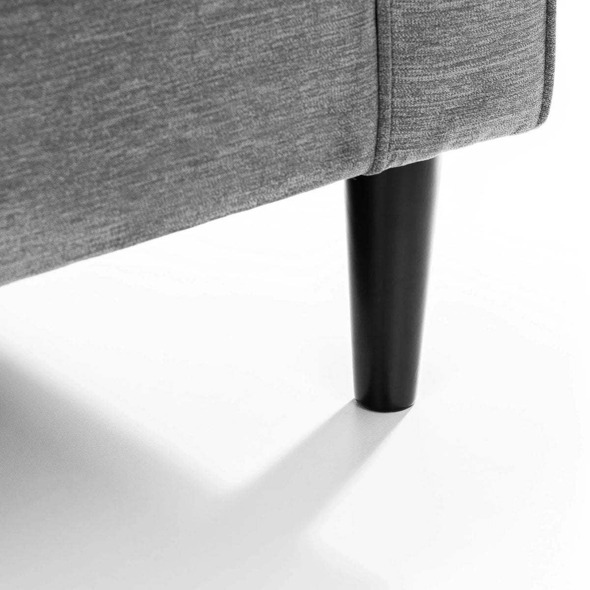 Hayward dark grey chenille chair corner with wooden leg detail on white background