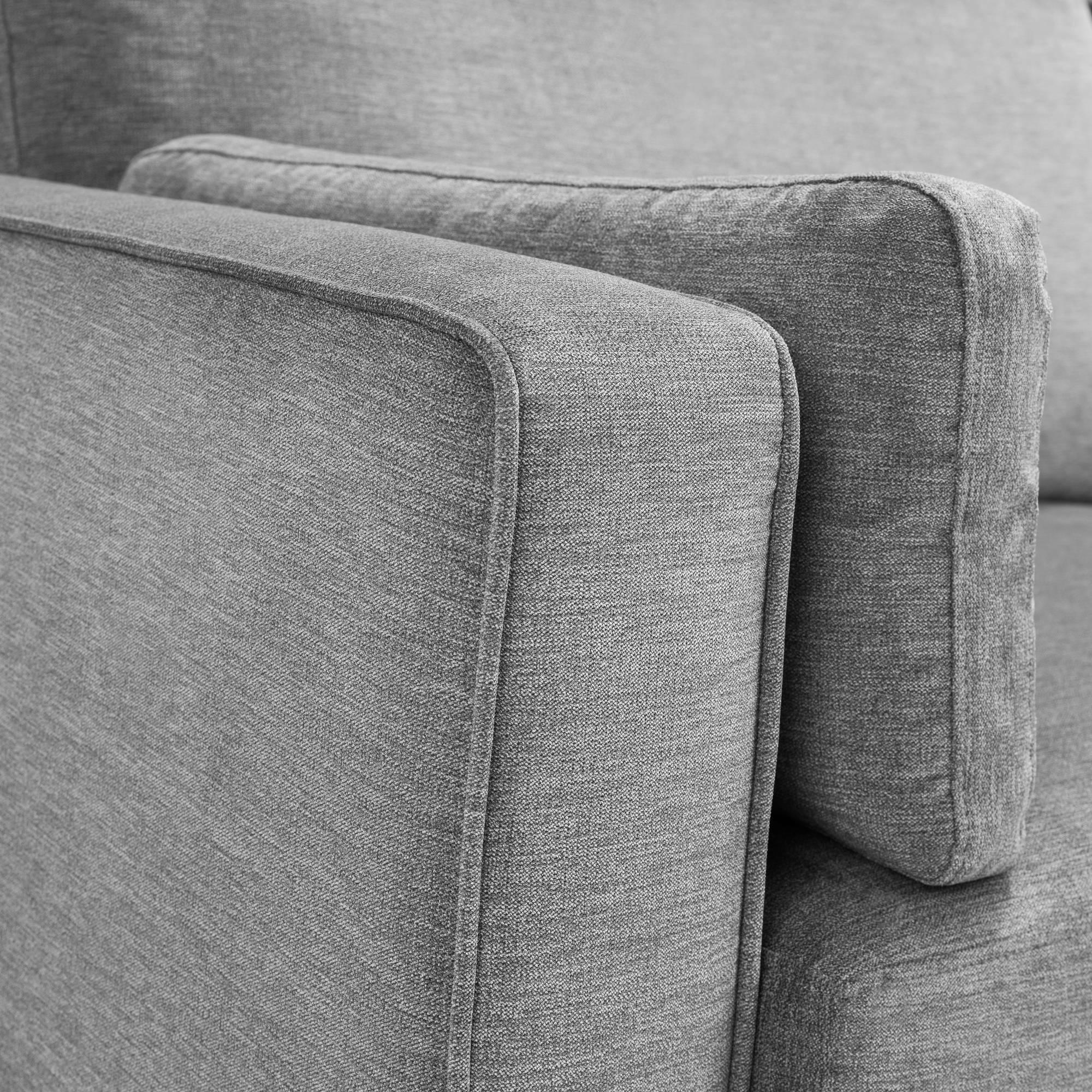 Close-up of dark grey chenille 2 seater sofa armrest and cushion detail