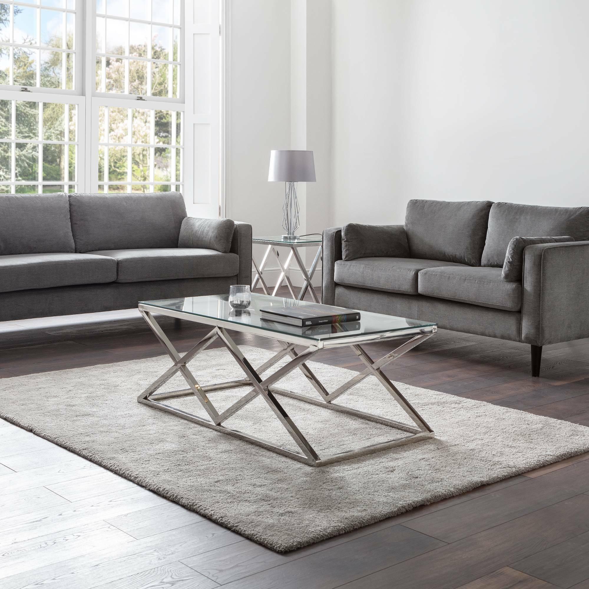 Dark grey chenille 2 seater and 3 seater sofas in modern living room with glass coffee table