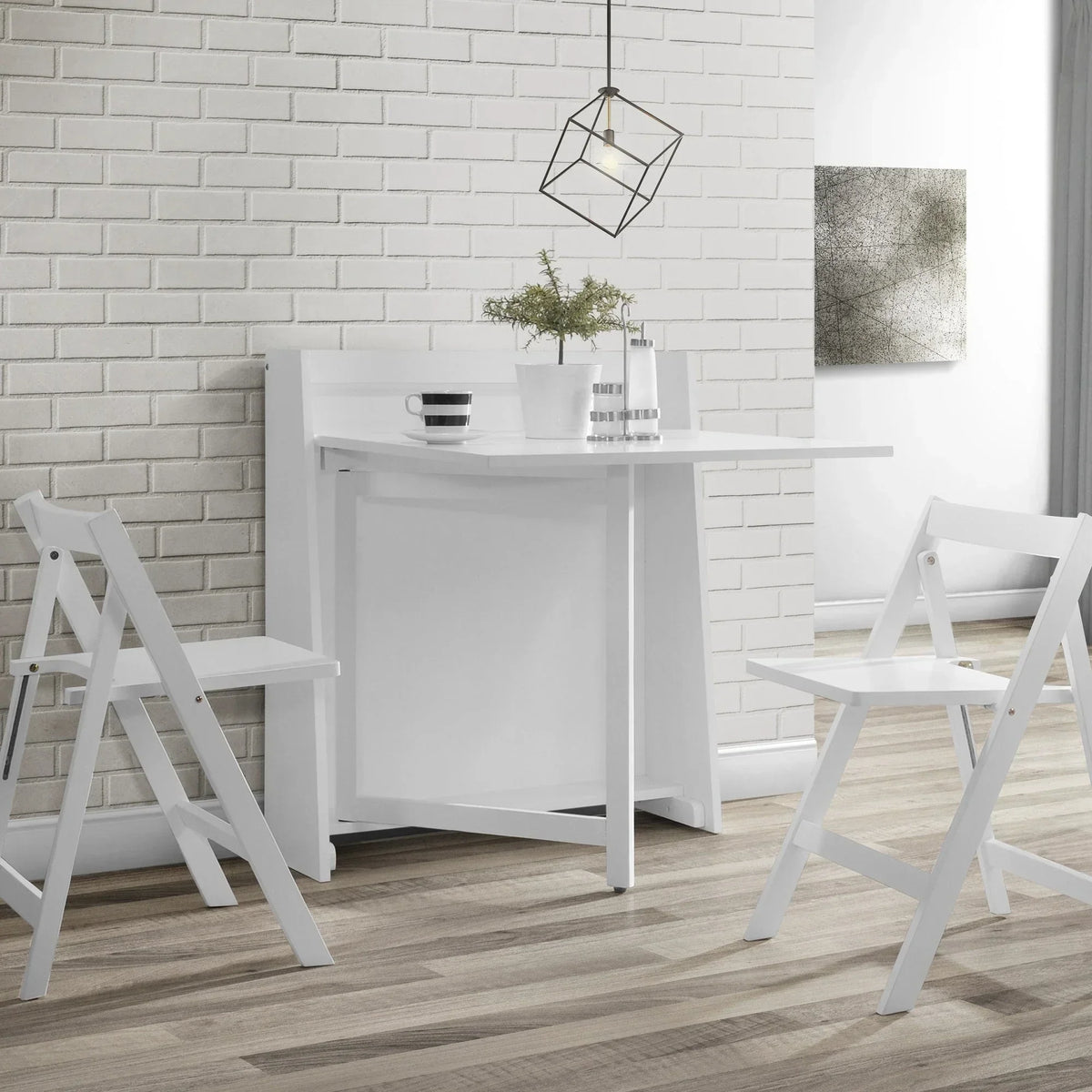 White compact folding dining set with two chairs in a modern room with brick wall