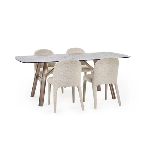 Modern dining table with patterned stone top and four beige upholstered chairs