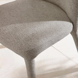 Light grey fabric dining chair seat and legs close-up on tiled floor