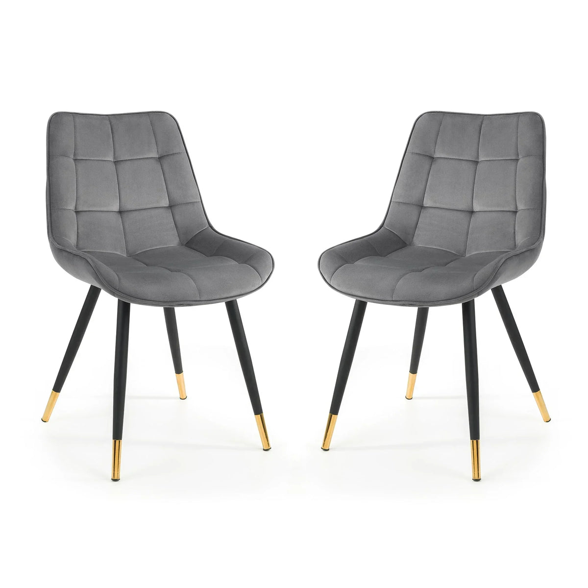 Set of two grey dining chairs with quilted seats and black legs featuring gold tips