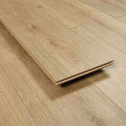 Harvest oak effect laminate flooring plank with wood grain texture shown on matching floor