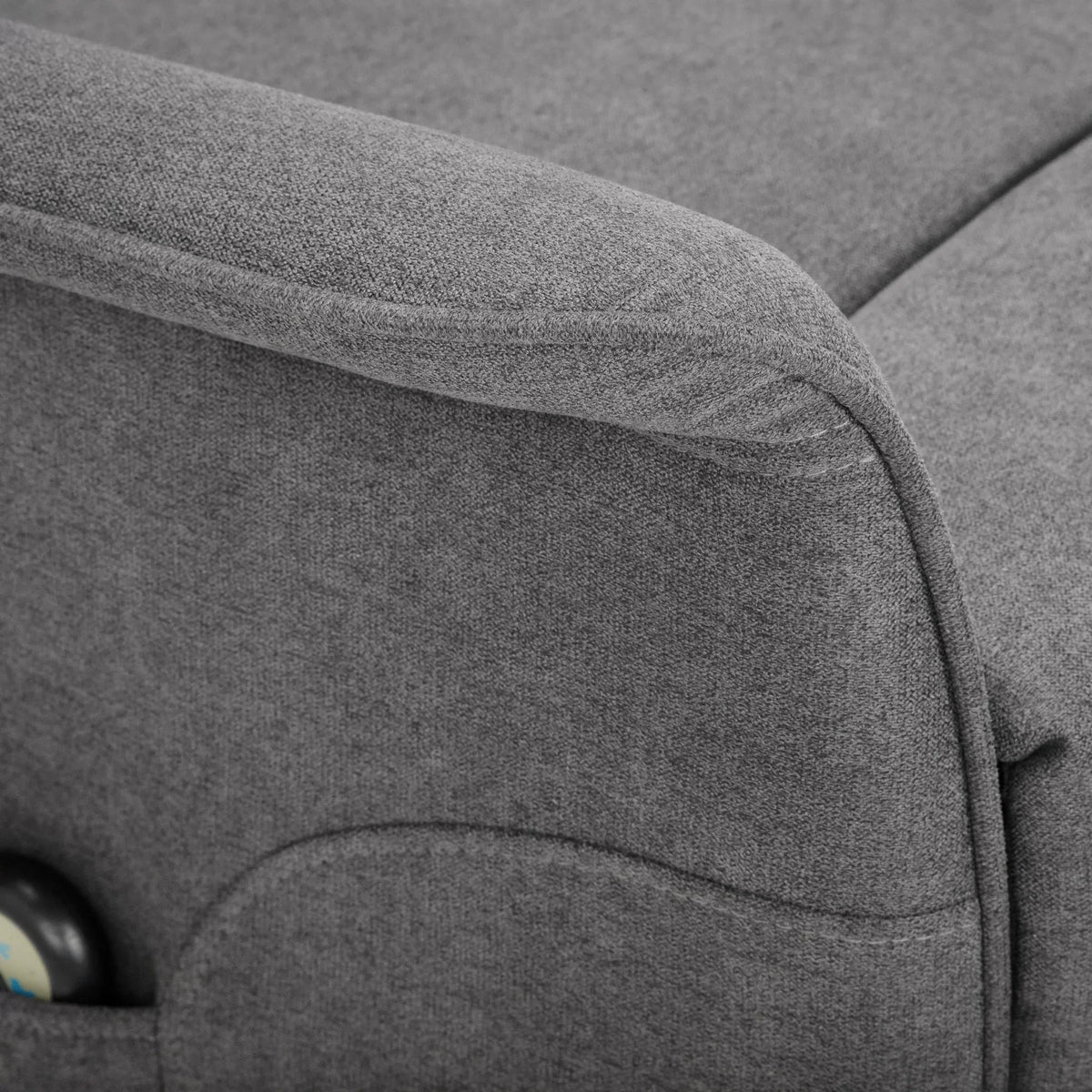 Charcoal grey fabric rise recliner chair arm detail with pocket and remote