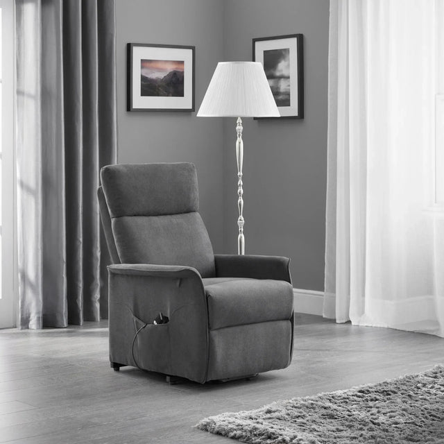 Charcoal rise recliner chair with remote in modern living room, floor lamp and wall art nearby