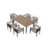Light brown wood table with six beige cushioned chairs and dark brown frames.