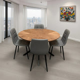 Round wood dining table with chevron pattern top and five grey padded dining chairs