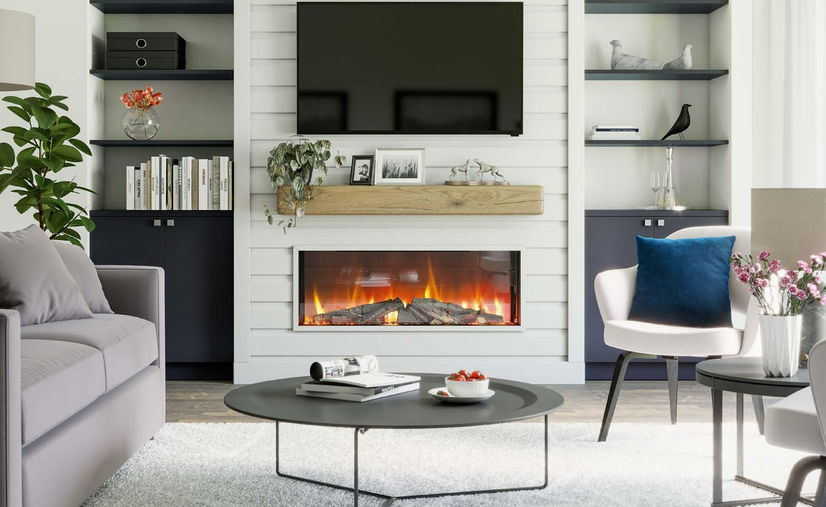 Modern living room interior with electric fire, grey sofa, blue cushions, and white coffee table