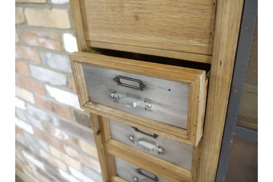 Wooden chest of drawers with metal label handles and one drawer partially open