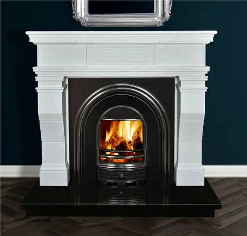 White marble fireplace with black arched insert and real wood fire on dark tile hearth