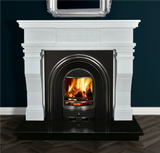 White marble fireplace with black arched insert and real wood fire on dark tile hearth