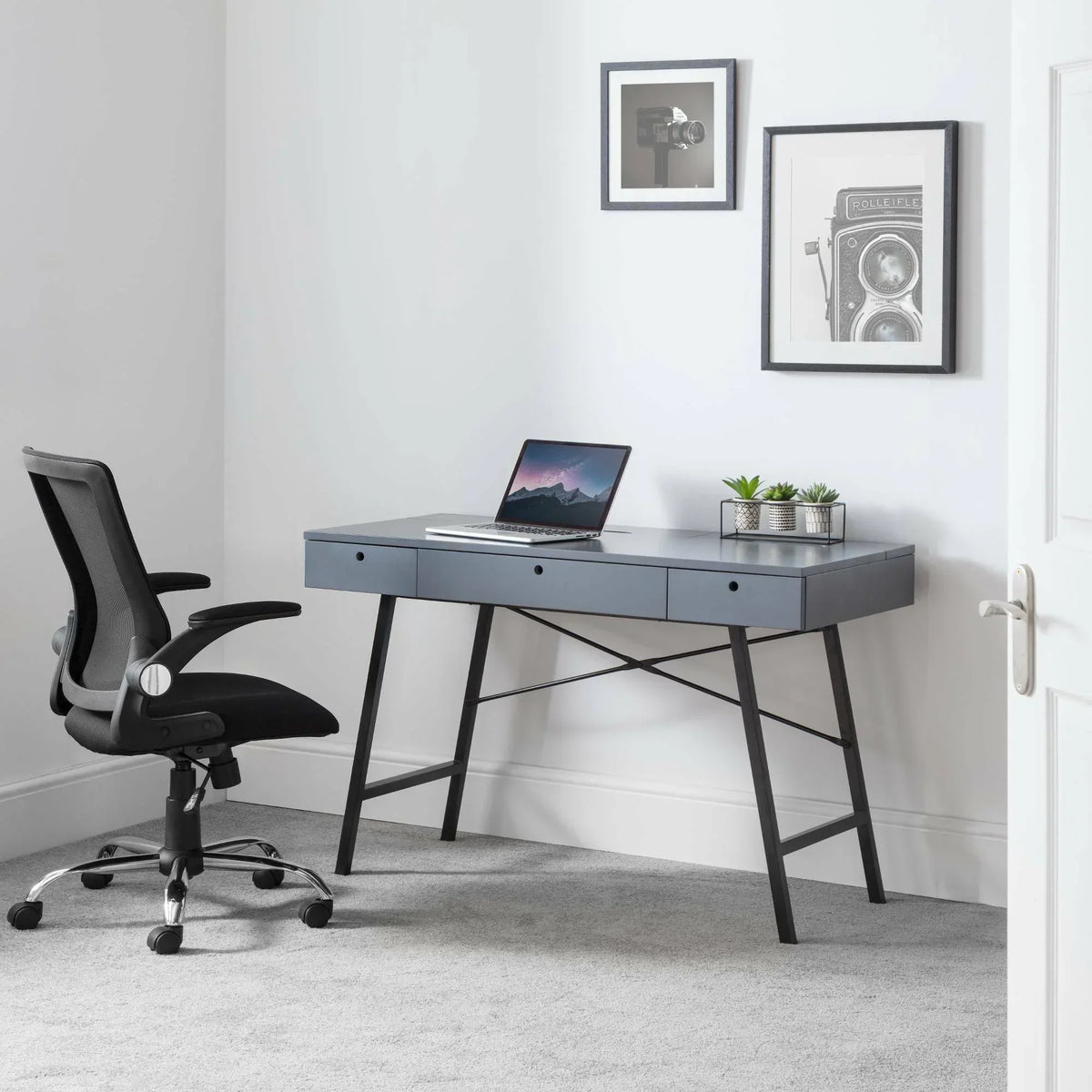 Imola office chair in black mesh and fabric at modern grey desk with laptop and plants