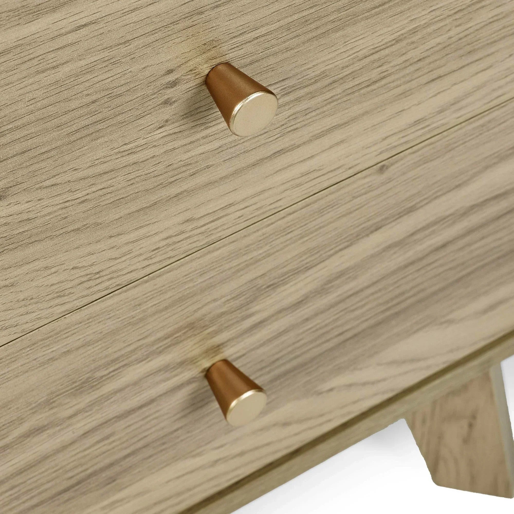Light oak chest of drawers with gold metal handles, close-up on wood grain and drawer detail