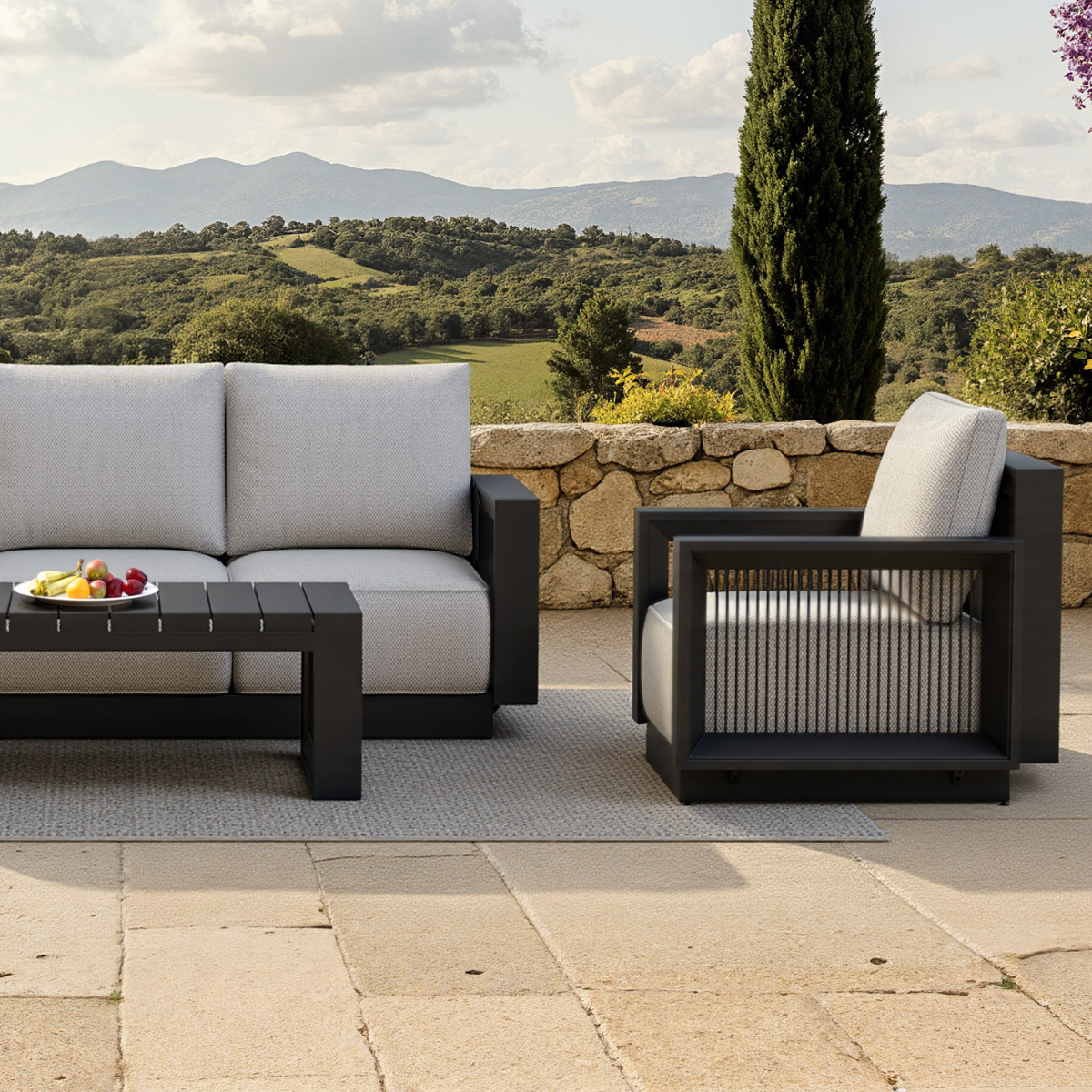 Light grey fabric cushions on black metal frame with slatted black coffee table outdoors