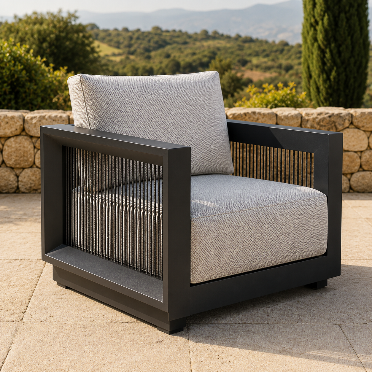 Light grey textured fabric cushions with black metal frame armchair on stone patio.