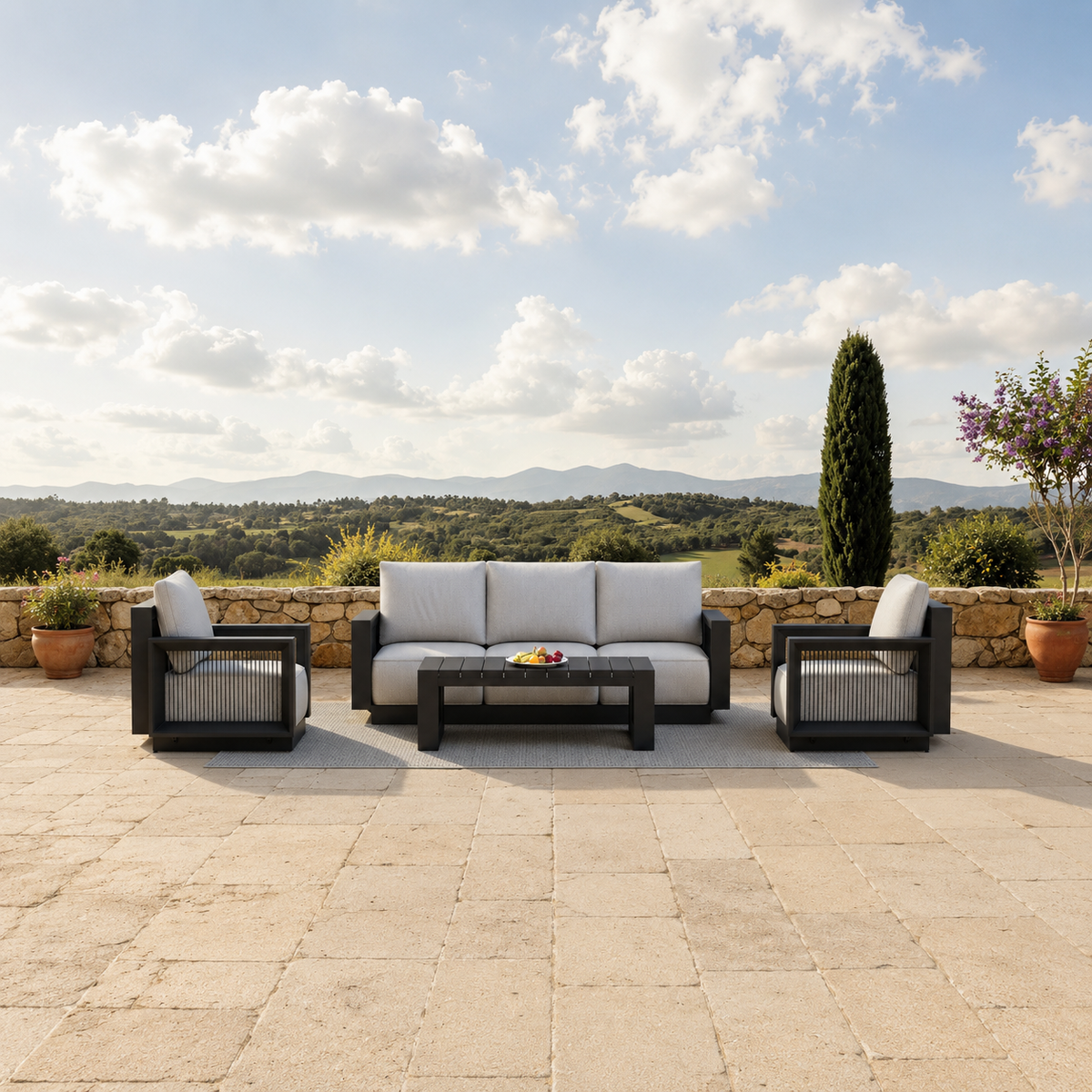 Black metal framed outdoor sofa set with light grey cushions on stone patio | Home Centre Direct UK