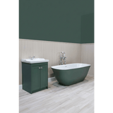 Bathroom with green freestanding bathtub and matching cabinet against a green wall.