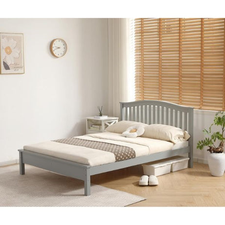 A single bed frame in a light gray finish, styled with cream bedding and a brown patterned throw blanket in a bright, modern bedroom setting with wooden blinds and a potted plant.